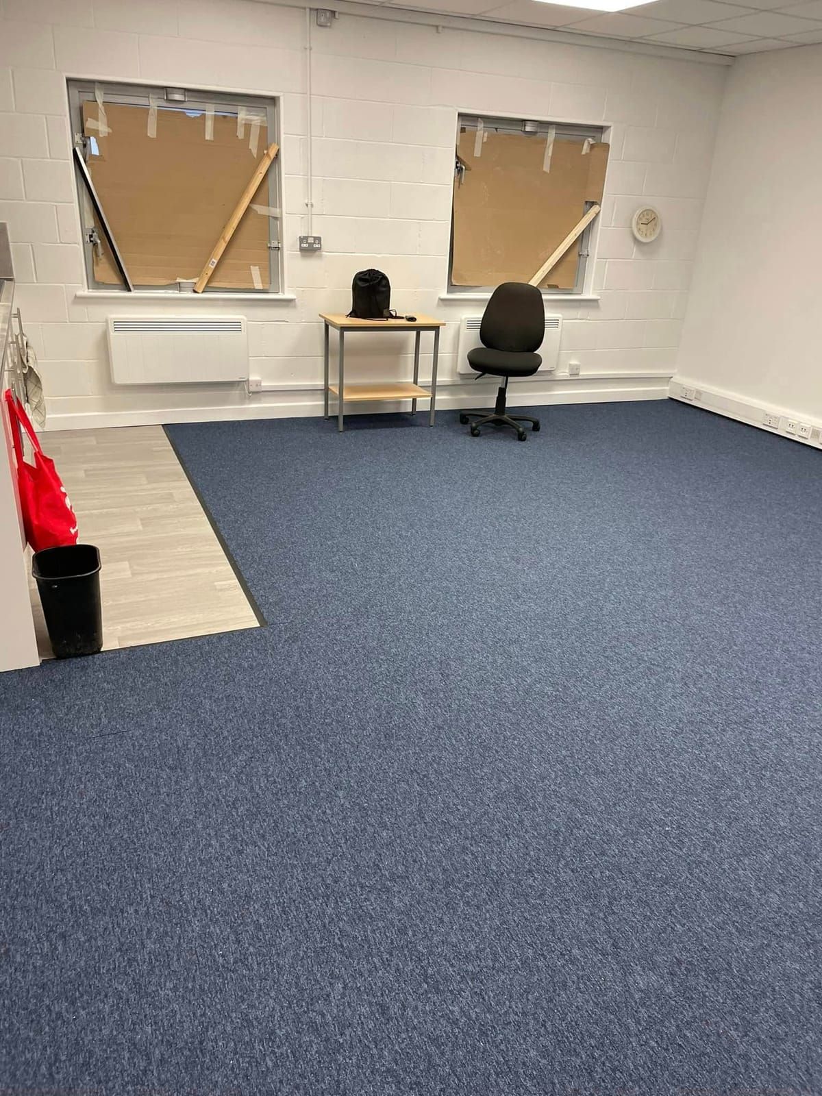 Blue office carpet tiles meeting a threshold