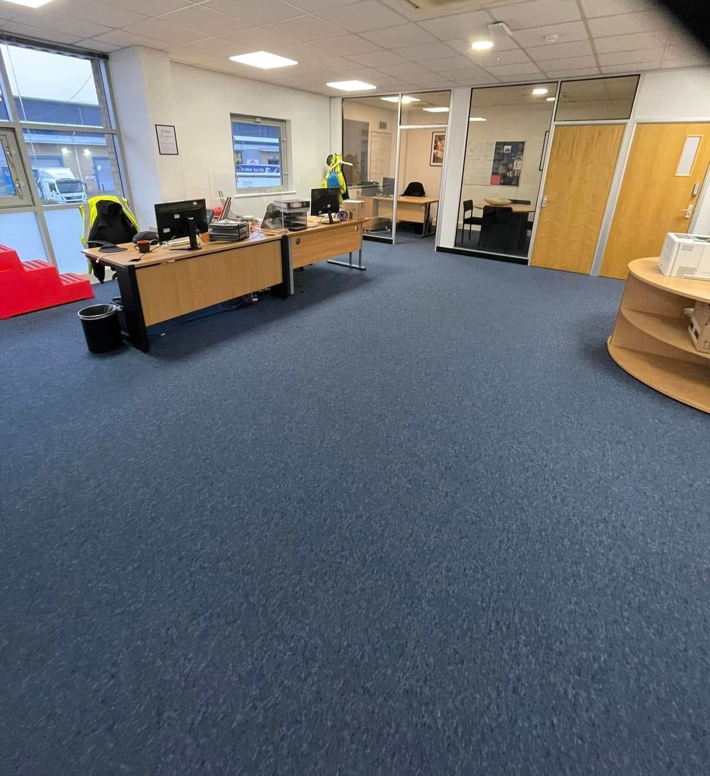 Blue carpet tiles across an open-plan office