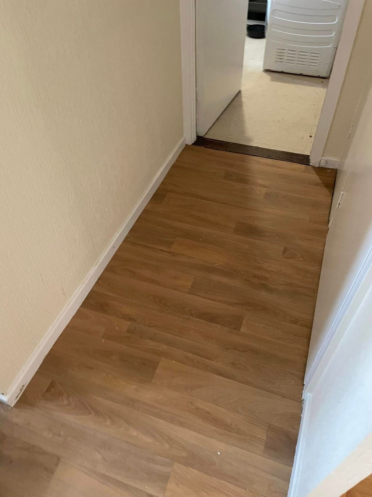 Oak laminate hallway leading to the front door