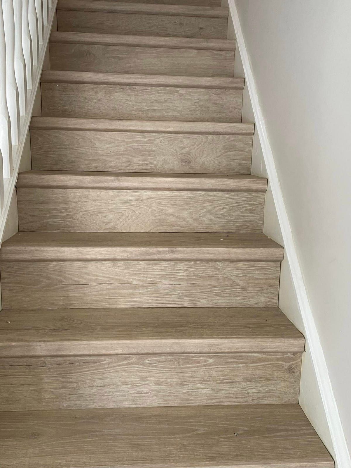 Light oak laminate cladding a full flight of stairs