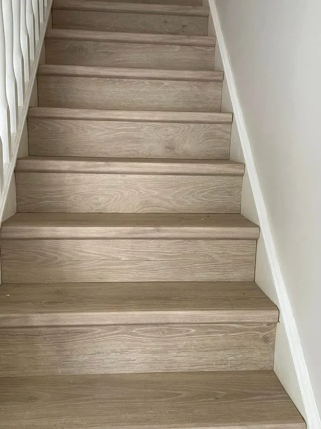 Light oak laminate cladding a full flight of stairs