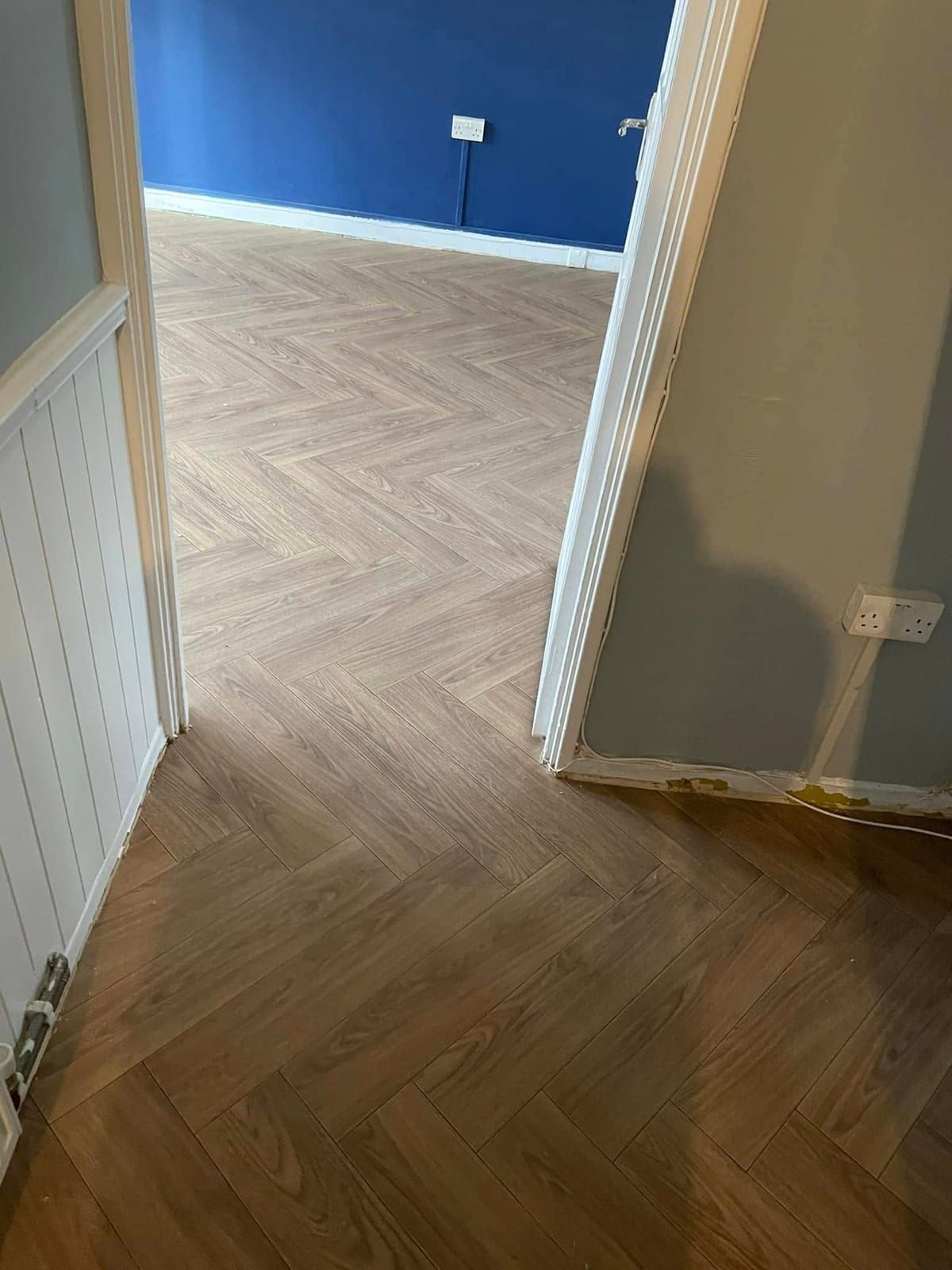Herringbone LVT running through a doorway