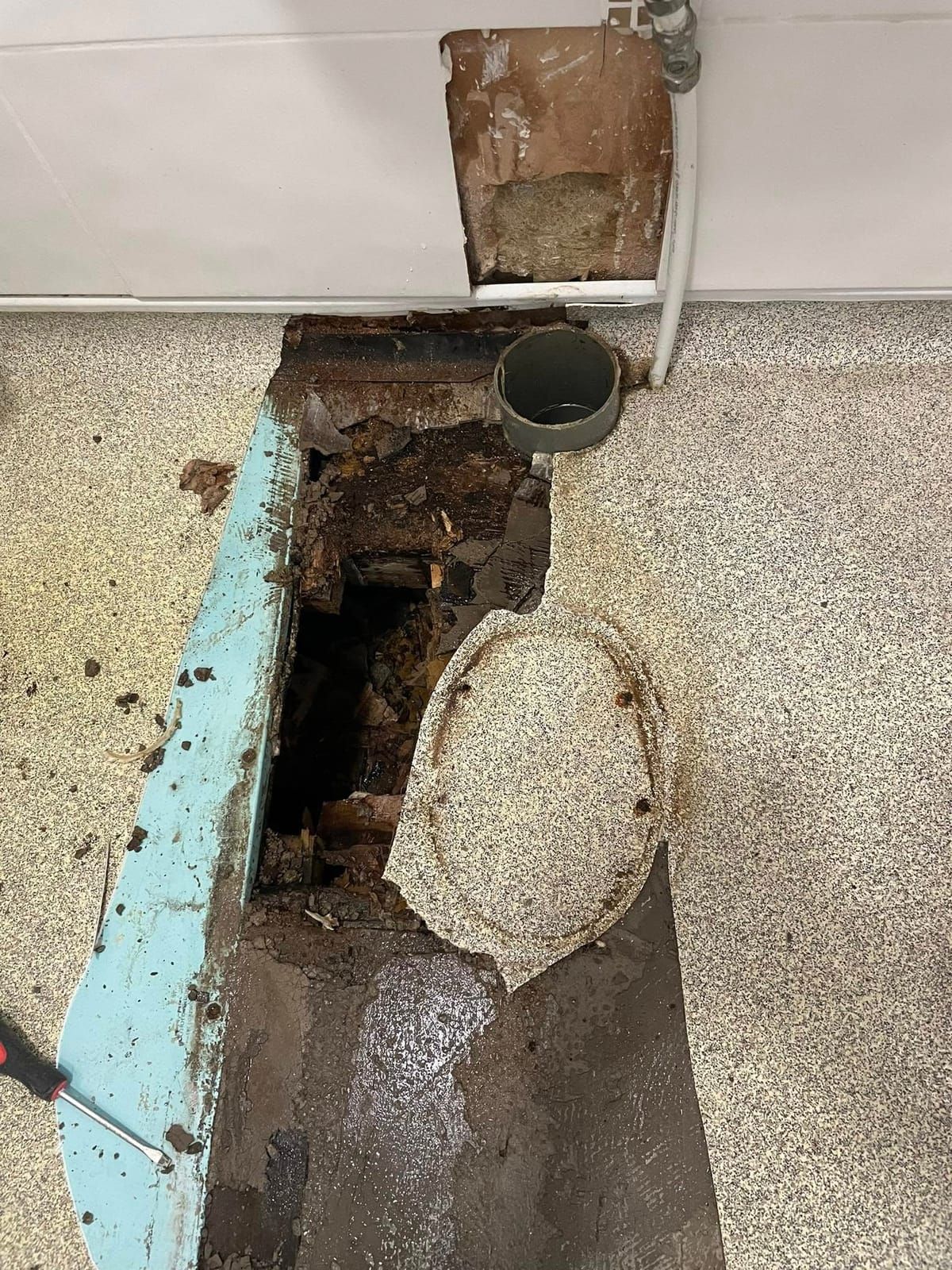 Rotten bathroom floor around a toilet waste, found when the old flooring came up