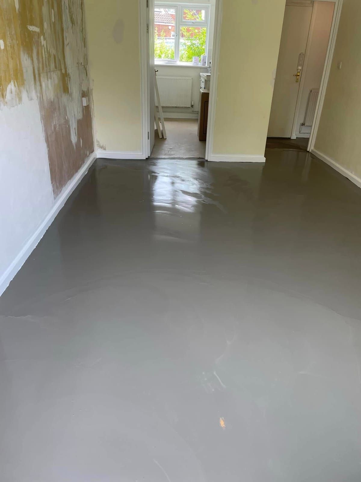 Fresh self-levelling screed poured and ready for new flooring