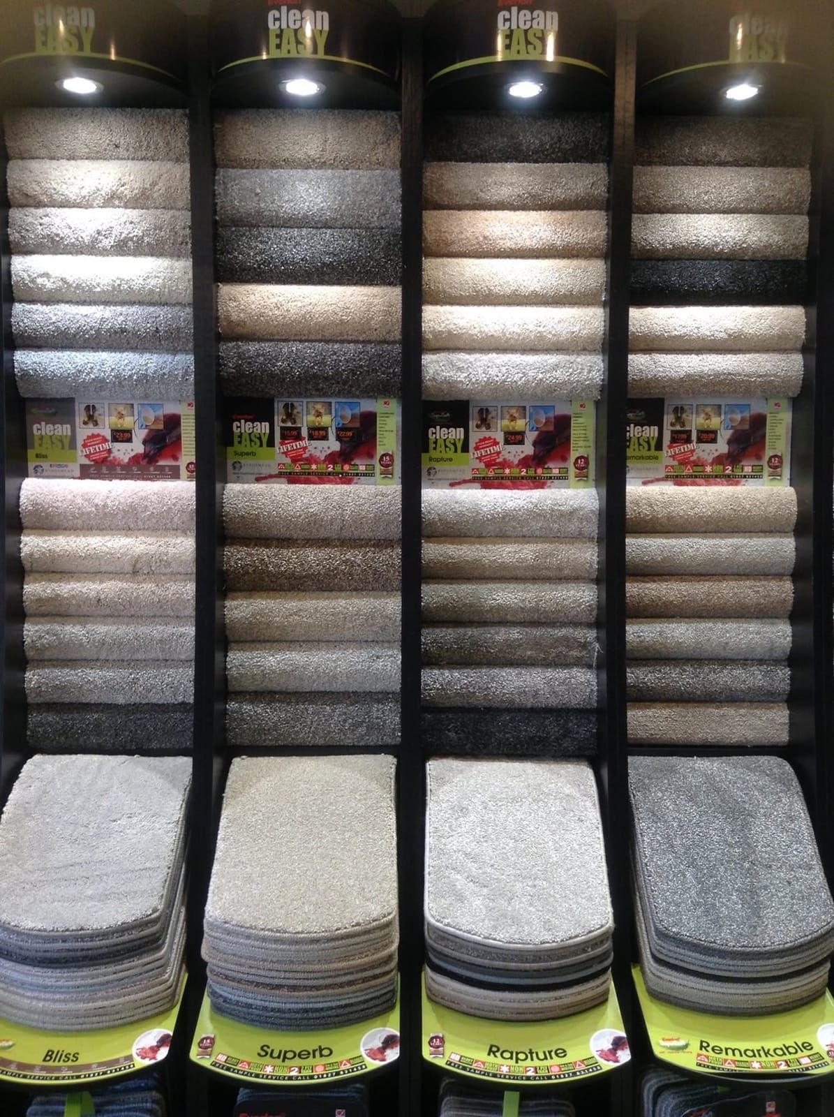 Lit carpet sample stands in the showroom