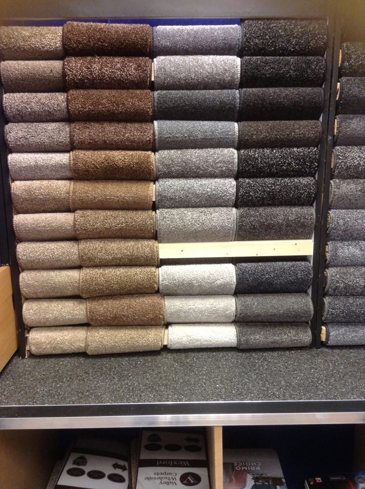 A wall of rolled carpet samples
