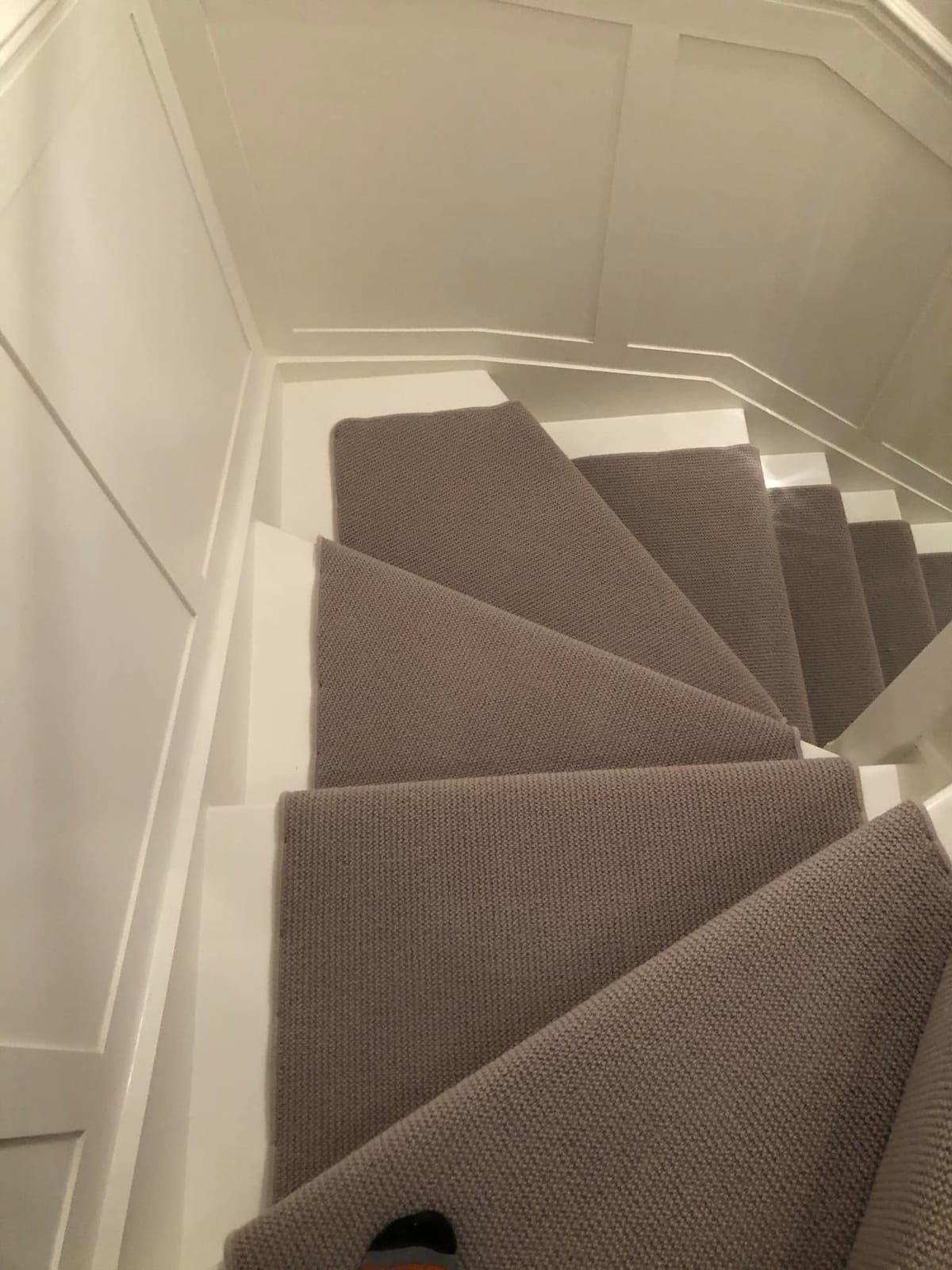 Taupe carpet on winder stairs, seen from above