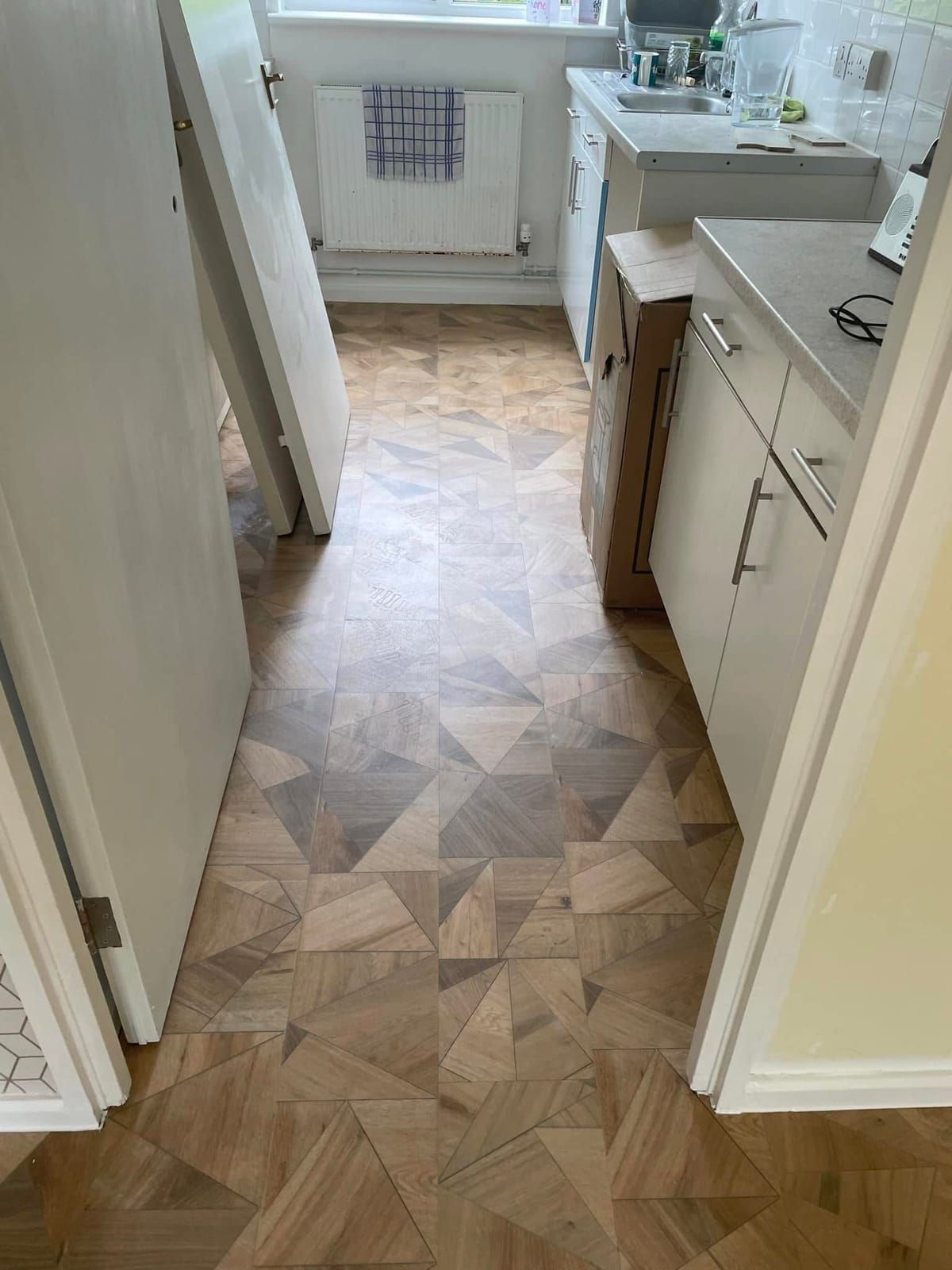 Geometric vinyl in a kitchen with white units