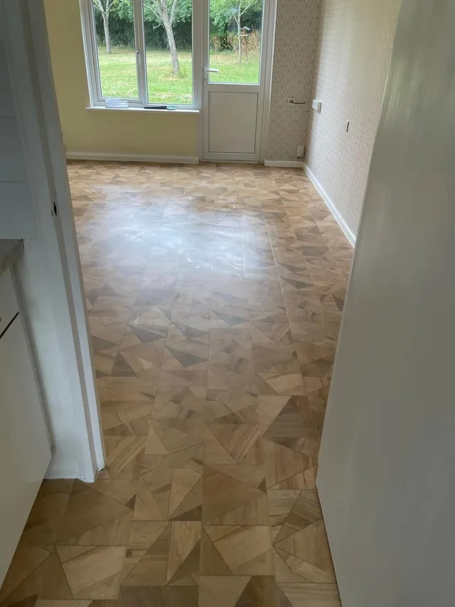 Geometric wood-effect vinyl in a room leading towards the front door