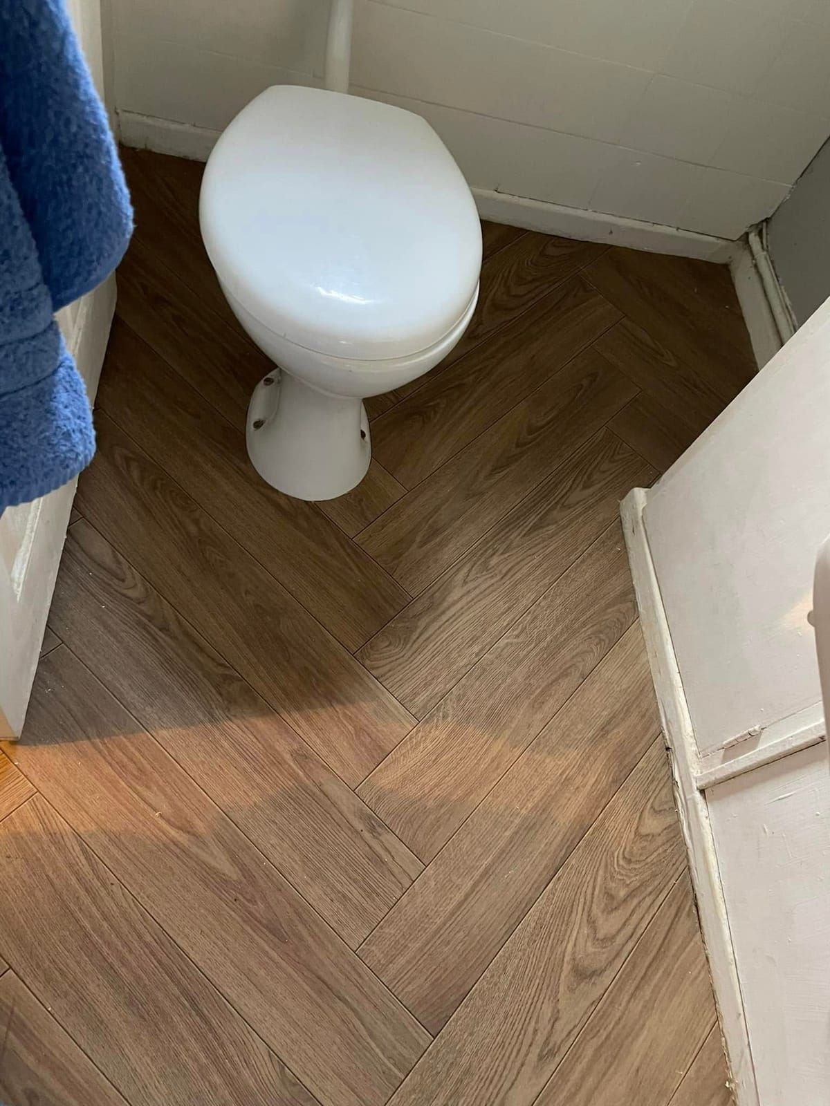 Herringbone flooring in a cloakroom WC