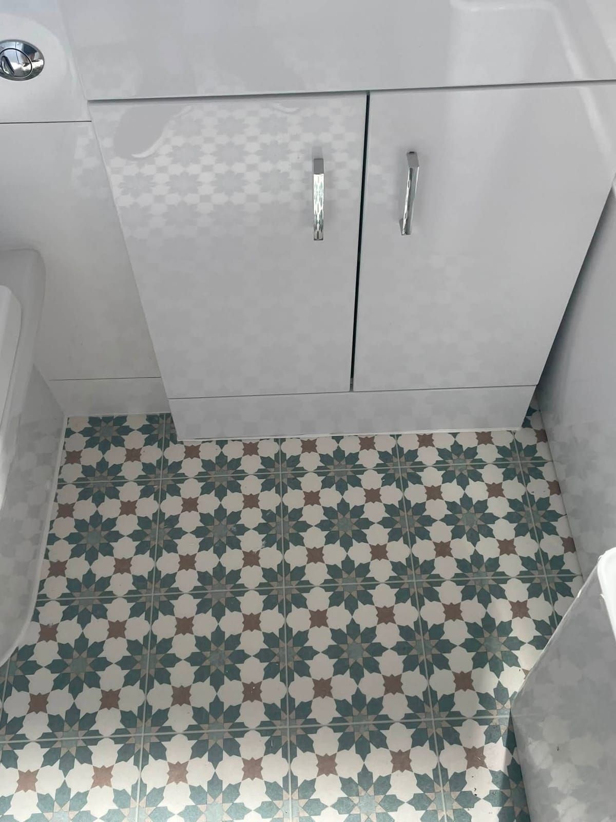 Blue and white patterned vinyl in a bathroom beside a white vanity unit