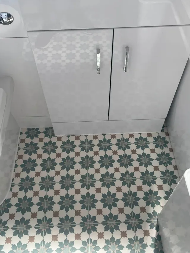 Blue and white patterned vinyl in a bathroom beside a white vanity unit